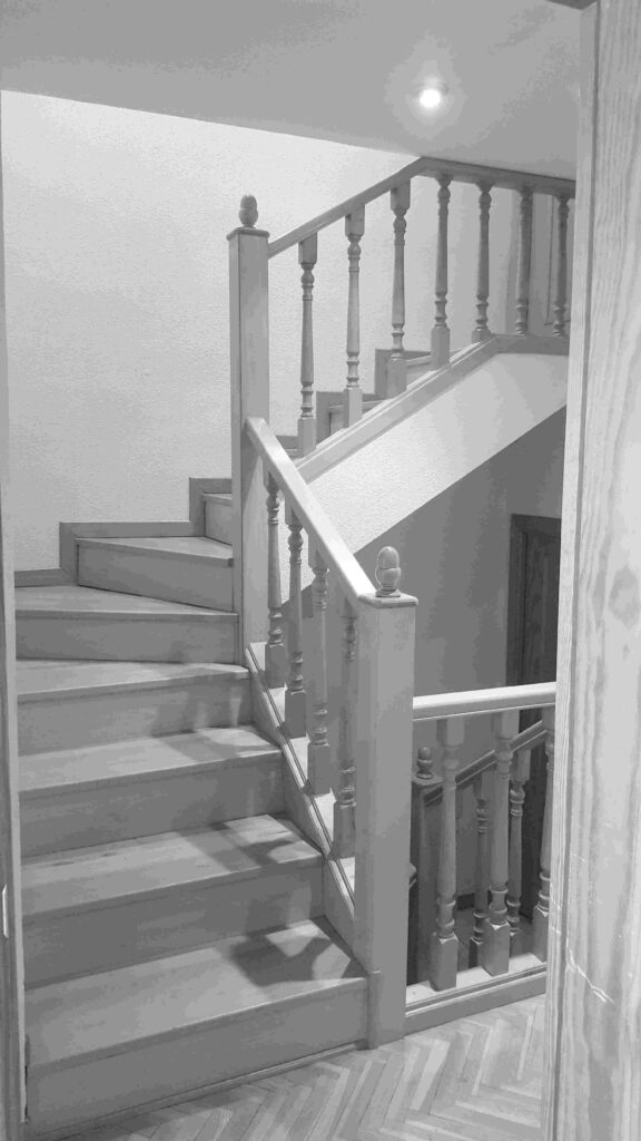 Escalera de madera original con barandilla de balaustres en la casa-estudio de Las Matas
